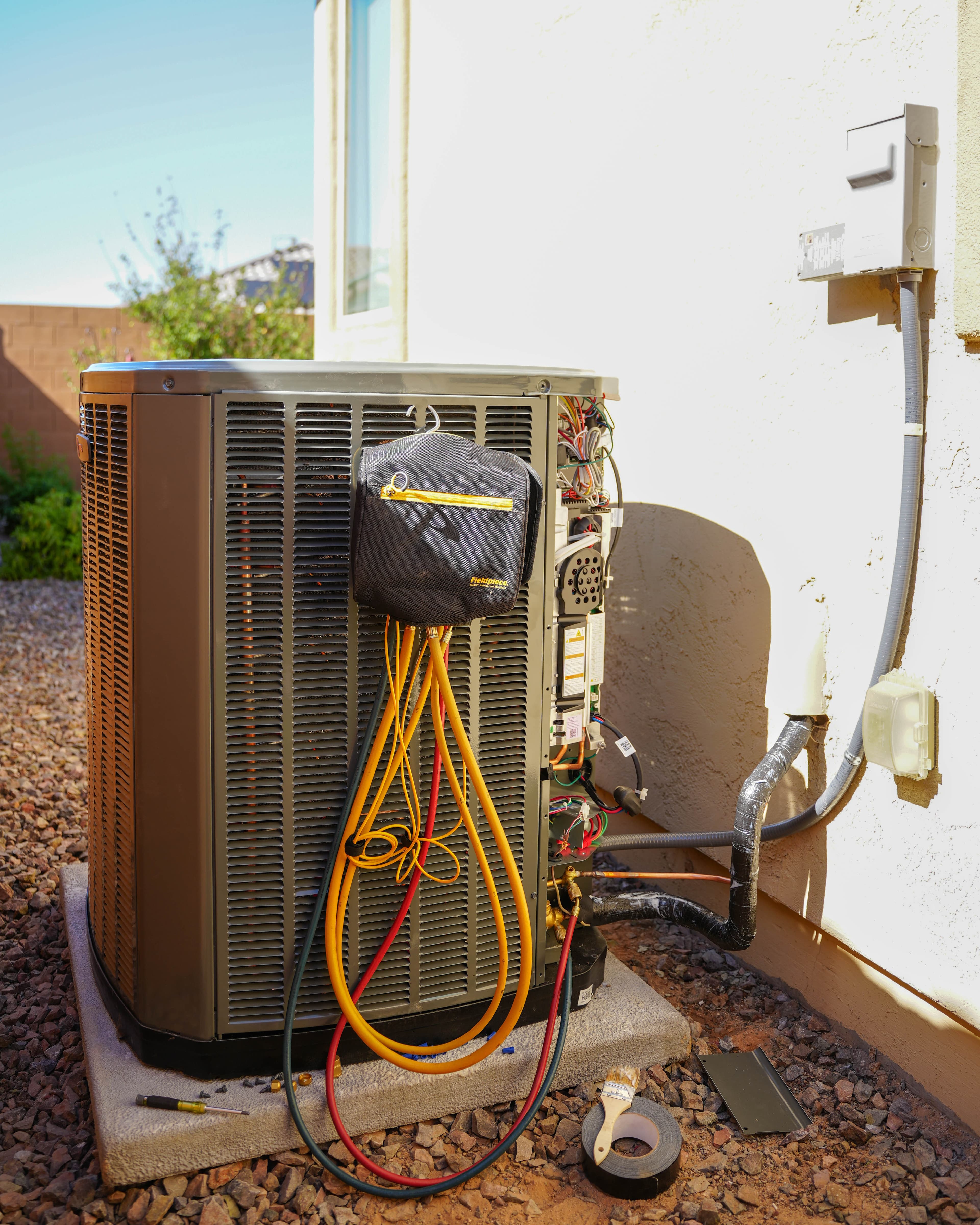 UFirst technician servicing an outdoor HVAC unit